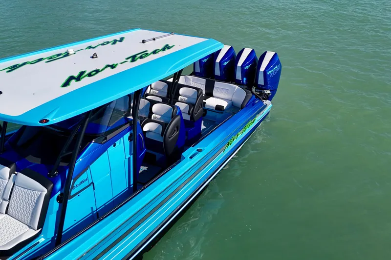 Slide: The Image of 2026 Nor-Tech 390 Sport Center Console boat on water, featuring vibrant blue design. - 15