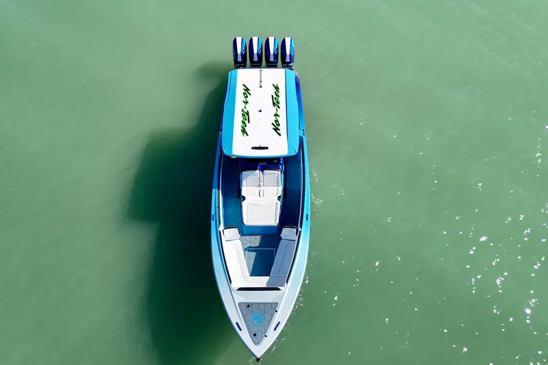 Slide: The Image of Aerial view of 2026 Nor-Tech 390 Sport Center Console boat on turquoise water. - 16