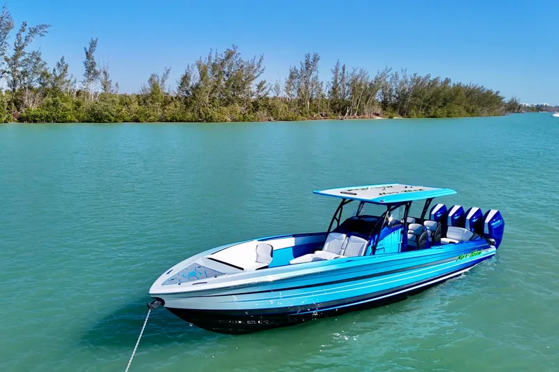 Slide: The Image of 2026 Nor-Tech 390 Sport Center Console boat on turquoise water, clear sky background. - 17