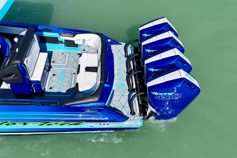 Slide: The Image of 2026 Nor-Tech 390 Sport Center Console with quad Racing 400 engines on turquoise water. - 23