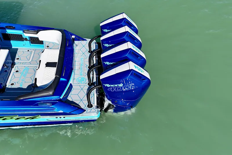 Slide: The Image of 2026 Nor-Tech 390 Sport Center Console with quad Racing 400 engines on turquoise water. - 24