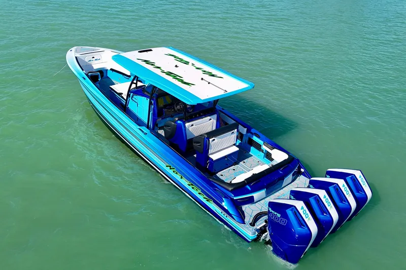 Slide: The Image of 2026 Nor-Tech 390 Sport Center Console boat with vibrant blue design on calm water. - 26