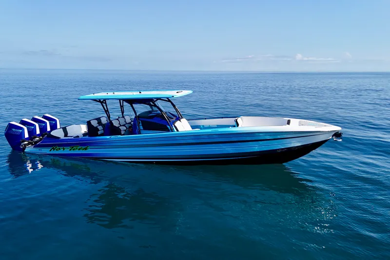 Slide: The Image of 2026 Nor-Tech 390 Sport Center Console boat on calm ocean waters. - 6