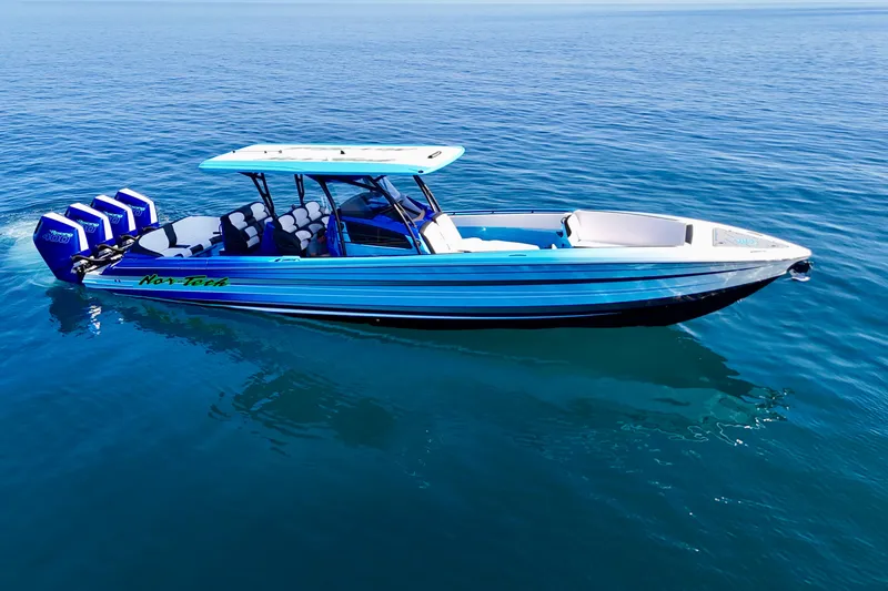 Slide: The Image of 2026 Nor-Tech 390 Sport Center Console boat on calm blue water. - 7