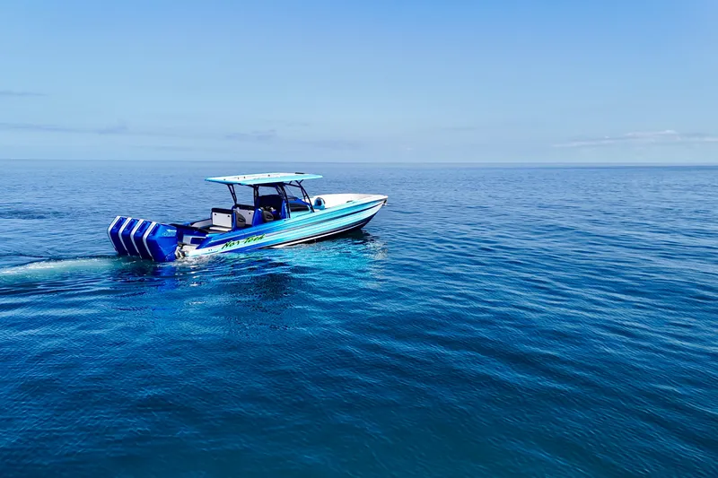 Slide: The Image of 2026 Nor-Tech 390 Sport Center Console cruising on open blue ocean. - 9