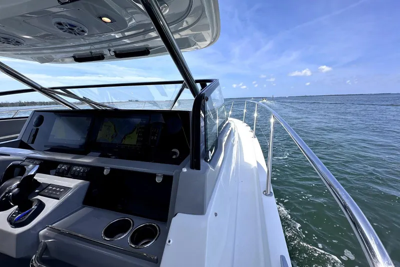 Slide: The Image of 2022 Jeanneau Leader 12.5 WA cruising on open water under clear blue skies. - 14
