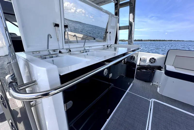 Slide: The Image of 2022 Jeanneau Leader 12.5 WA boat interior with sleek kitchen area and ocean view. - 20