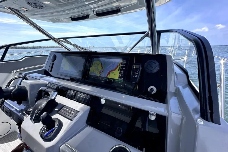 Slide: The Image of Helm of 2022 Jeanneau Leader 12.5 WA with advanced navigation displays and controls. - 22