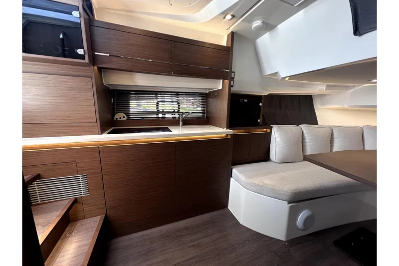 Slide: The Image of Interior of 2022 Jeanneau Leader 12.5 WA yacht with modern kitchen and seating area. - 26