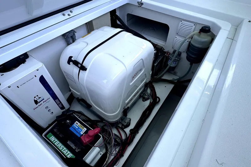 Slide: The Image of Engine compartment of 2022 Jeanneau Leader 12.5 WA with generator and battery setup. - 34