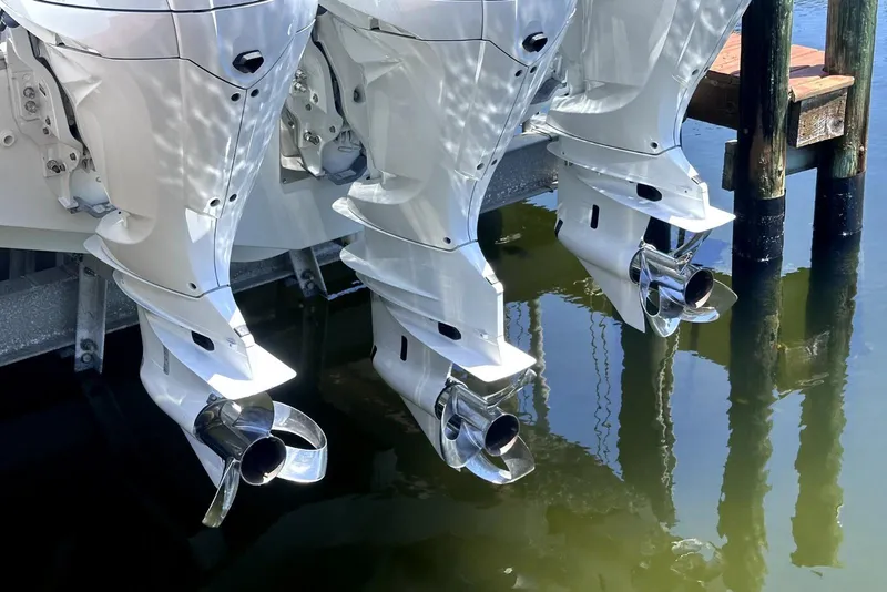 Slide: The Image of Triple outboard motors on a 2022 Jeanneau Leader 12.5 WA boat docked in water. - 38