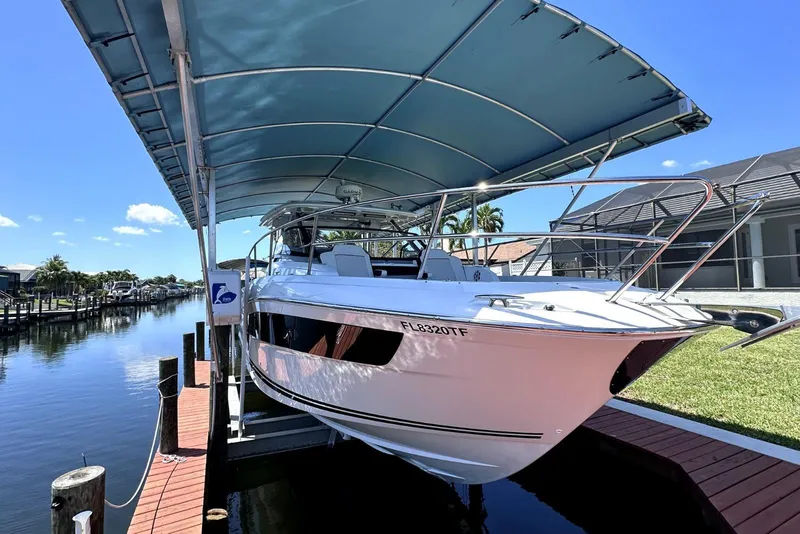 Slide: The Image of 2022 Jeanneau Leader 12.5 WA boat docked under canopy on sunny day. - 39