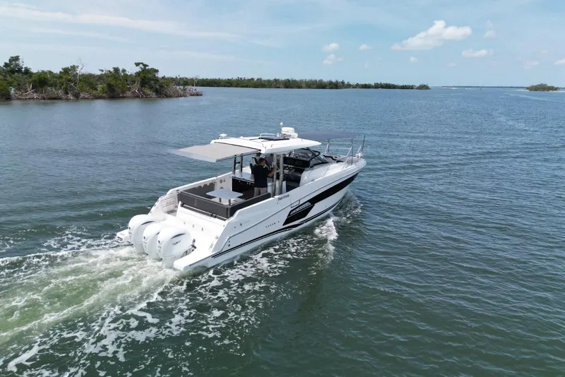 Slide: The Image of 2022 Jeanneau Leader 12.5 WA cruising on open water, rear view. - 4