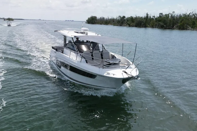 Slide: The Image of 2022 Jeanneau Leader 12.5 WA cruising on a calm waterway. - 5