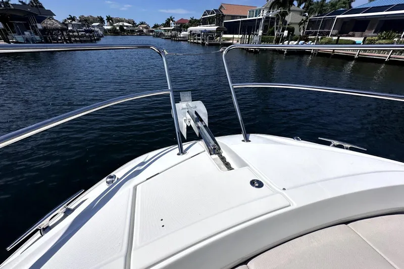 Slide: The Image of Bow view of 2022 Jeanneau Leader 12.5 WA boat in a serene marina setting. - 8