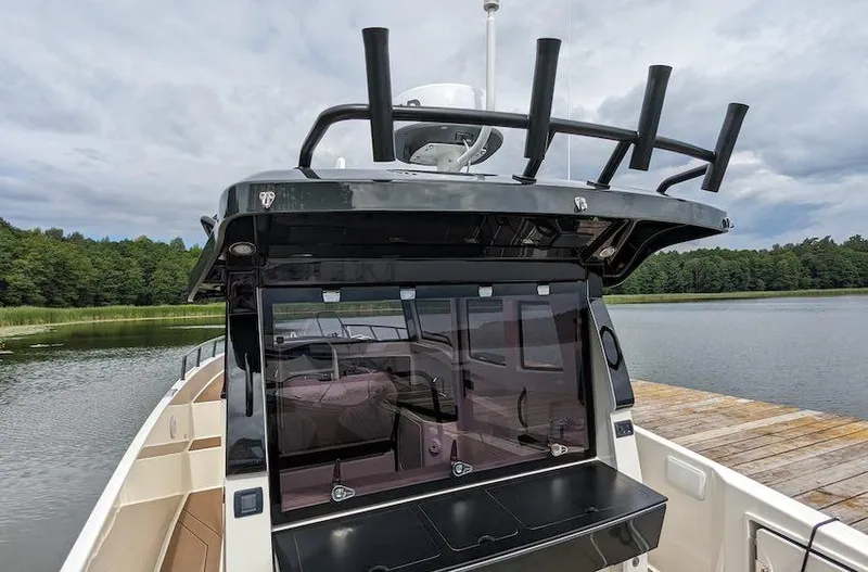 Slide: The Image of Navan C30 boat, 2025 model, docked by a serene lake with lush greenery. - 12
