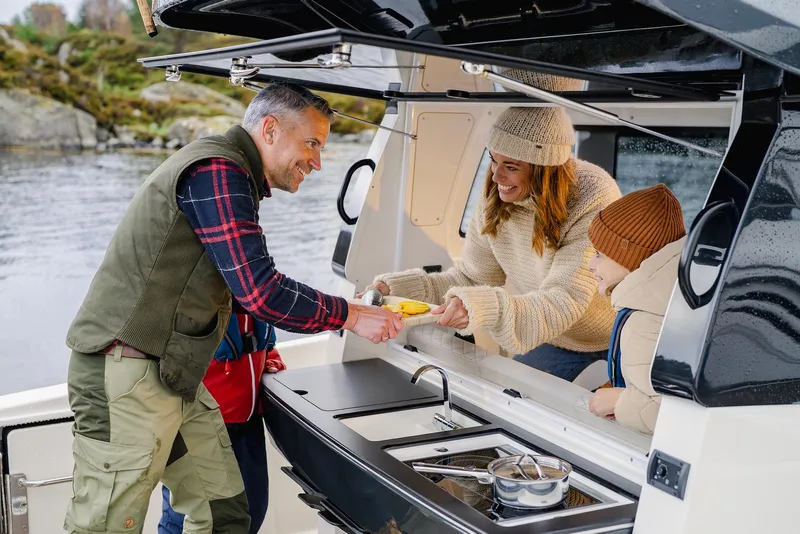Slide: The Image of Family enjoying outdoor meal on Navan C30 boat, 2025 model, by the water. - 6