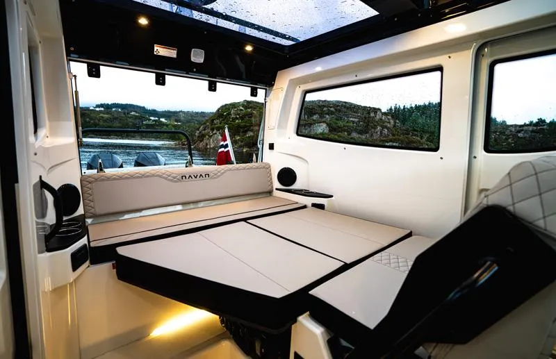 Slide: The Image of Luxurious interior of 2025 Navan C30 boat with convertible seating and scenic window view. - 7