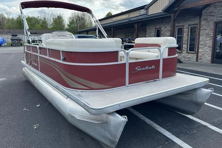 Slide: The Image of 2014 Godfrey Sweetwater 2086 C pontoon boat with red exterior, parked outdoors. - 10