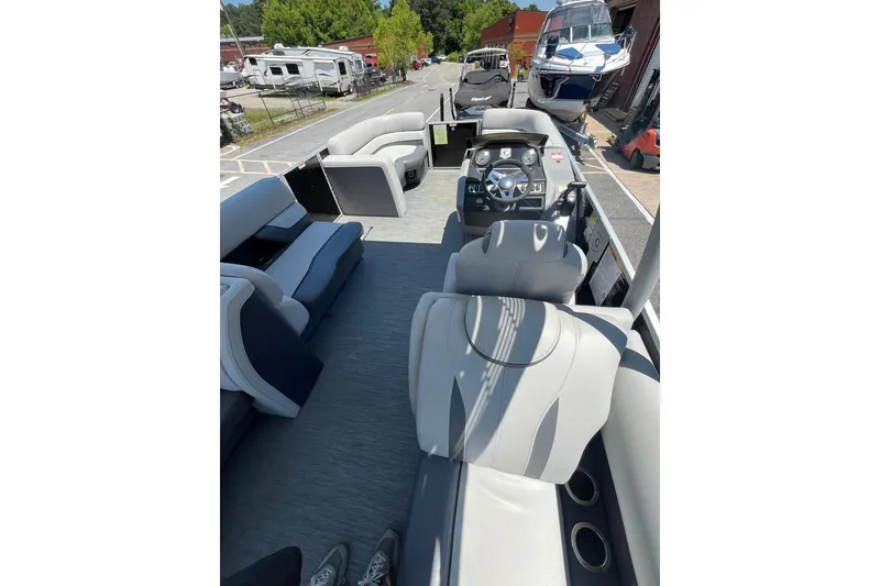 Slide: The Image of 2023 Godfrey Monaco 235 SD pontoon boat interior with plush seating and modern dashboard. - 11