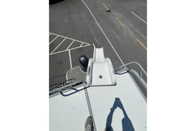 Slide: The Image of 2023 Godfrey Monaco 235 SD boat with slide, viewed from above in a parking lot. - 13