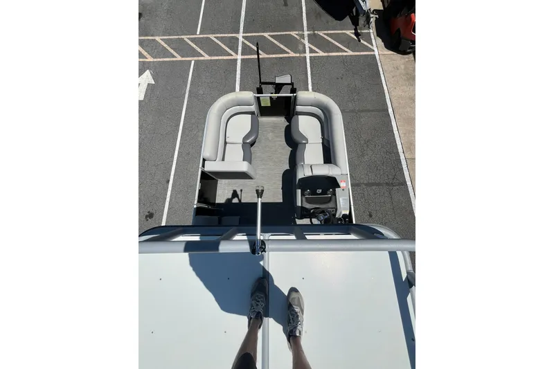 Slide: The Image of Overhead view of 2023 Godfrey Monaco 235 SD pontoon boat in a parking lot. - 14
