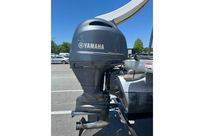 Slide: The Image of Yamaha outboard motor on 2023 Godfrey Monaco 235 SD boat, parked outdoors. - 15