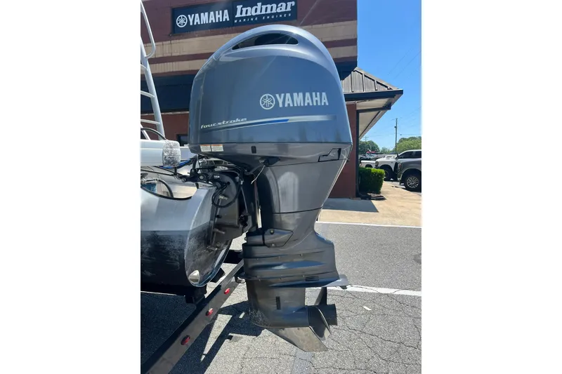Slide: The Image of Yamaha outboard motor on a 2023 Godfrey Monaco 235 SD boat, parked outside dealership. - 16