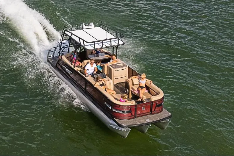 Slide: The Image of Manufacturer Provided Image: 2023 Godfrey Monaco 235 SD pontoon boat cruising on water with passengers. - 18