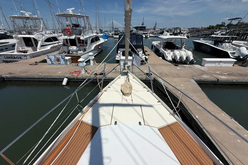 Slide: The Image of Bow view of 1980 Amel Mango 52 yacht docked at a marina with other boats. - 12