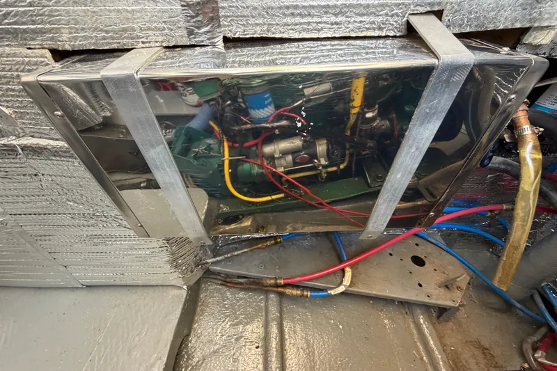 Slide: The Image of Engine compartment of a 1980 Amel Mango 52 sailboat, showing wiring and insulation. - 64