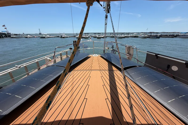 Slide: The Image of Deck view of 1980 Amel Mango 52 sailboat docked in a marina. - 31