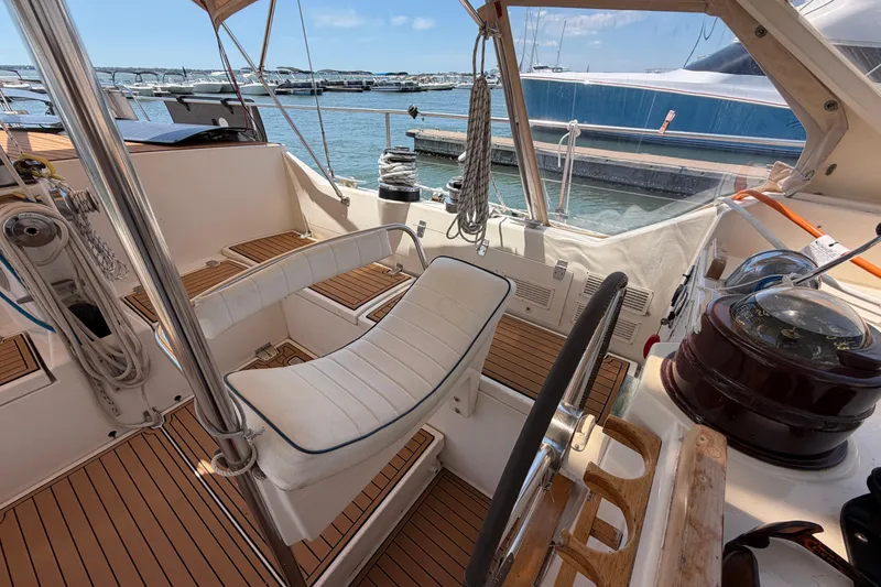Slide: The Image of Cockpit of 1980 Amel Mango 52 sailboat with wooden deck and steering wheel. - 29