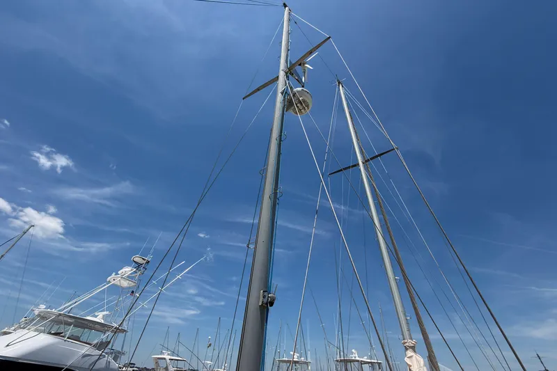 Slide: The Image of Masts of 1980 Amel Mango 52 sailboat against a clear blue sky. - 19