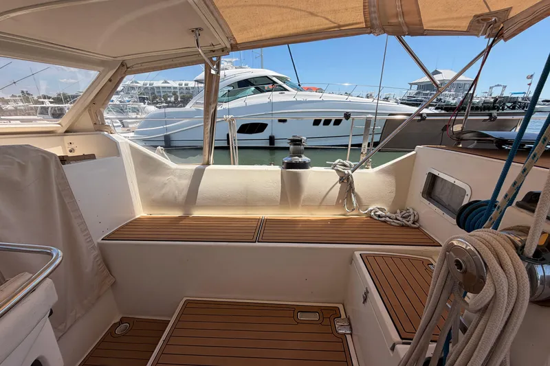 Slide: The Image of Cockpit of 1980 Amel Mango 52 sailboat with marina view. - 30