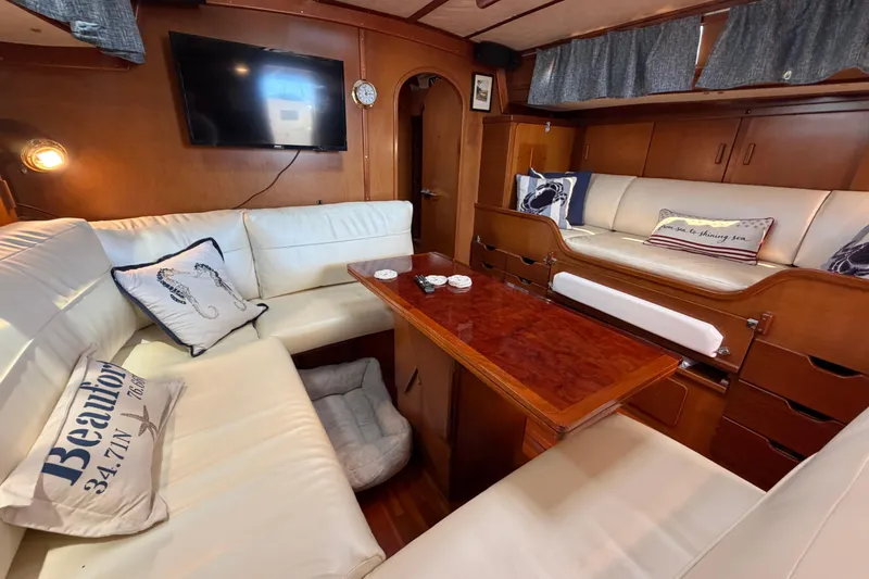 Slide: The Image of Luxurious interior of 1980 Amel Mango 52 yacht with white seating and wooden accents. - 36