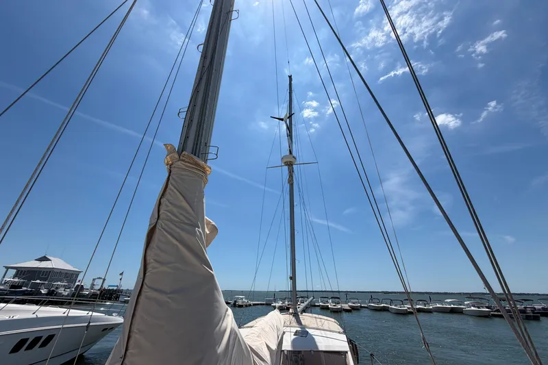 Slide: The Image of Sailboat Amel Mango 52, 1980 model, docked under clear blue sky. - 18