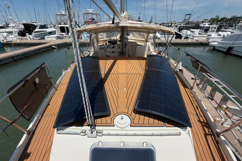 Slide: The Image of Amel Mango 52 sailboat deck with solar panels, docked at marina, 1980 model. - 25