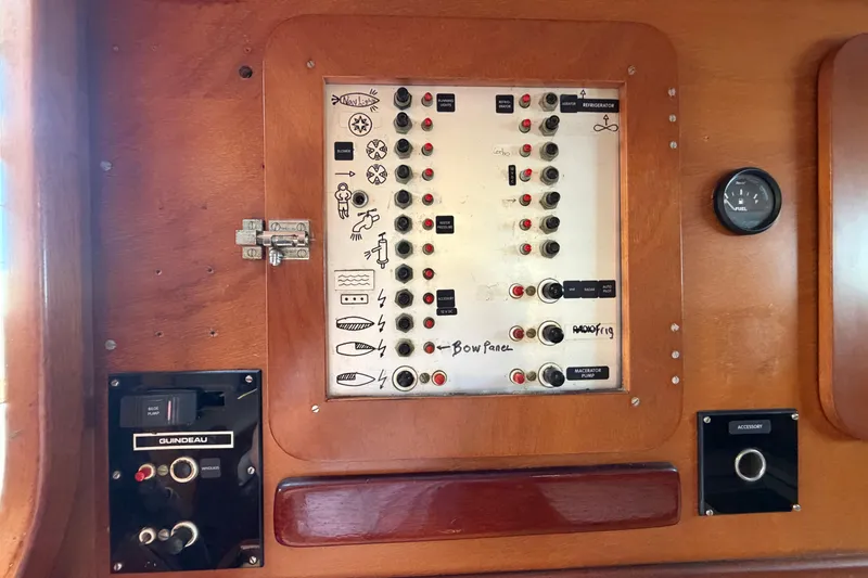 Slide: The Image of Control panel of a 1980 Amel Mango 52 yacht with various switches and gauges. - 58