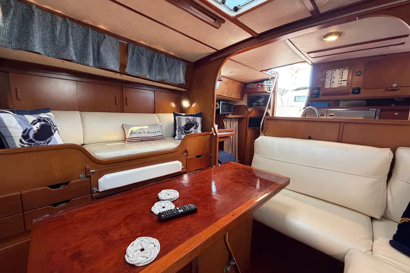 Slide: The Image of Interior of 1980 Amel Mango 52 yacht with wooden furnishings and white seating. - 39