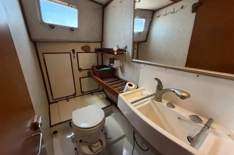 Slide: The Image of Bathroom interior of 1980 Amel Mango 52 yacht, featuring sink and toilet. - 52