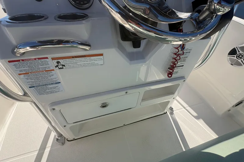 Slide: The Image of 2019 Robalo R180 Center Console helm with steering wheel and control panel. - 10