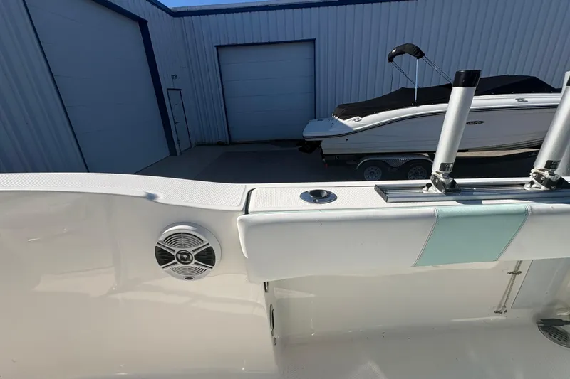 Slide: The Image of 2019 Robalo R180 Center Console boat interior with speaker and rod holders. - 11