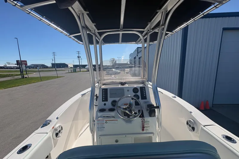 Slide: The Image of 2019 Robalo R180 Center Console boat with steering wheel and navigation equipment. - 12