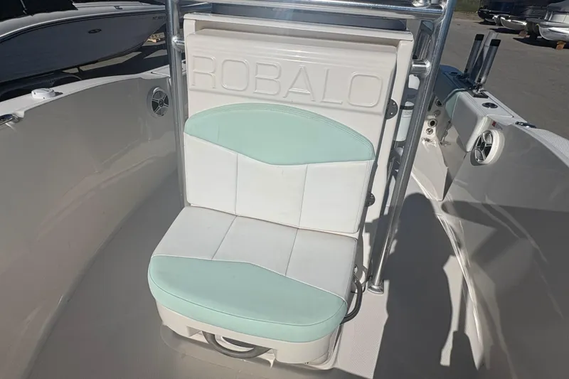 Slide: The Image of 2019 Robalo R180 Center Console boat seat with mint green and white upholstery. - 14