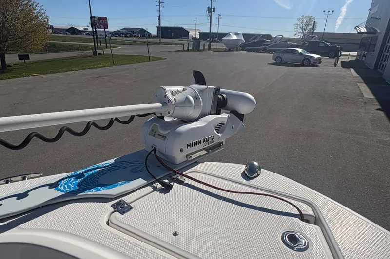 Slide: The Image of 2019 Robalo R180 Center Console with Minn Kota trolling motor in parking lot. - 15