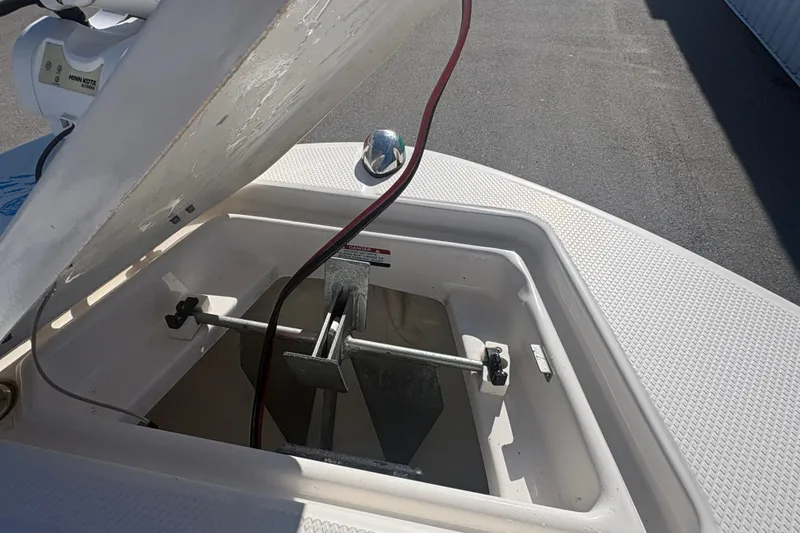 Slide: The Image of 2019 Robalo R180 Center Console anchor storage compartment open on deck. - 16