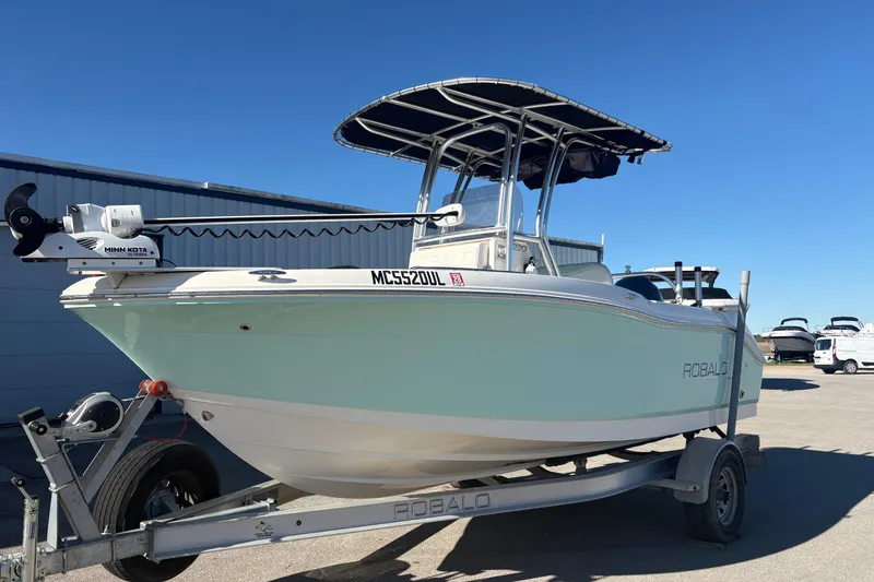 Slide: The Image of 2019 Robalo R180 Center Console boat on trailer, featuring Minn Kota trolling motor. - 3