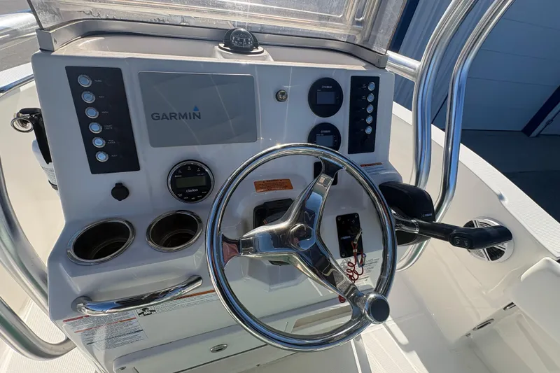 Slide: The Image of 2019 Robalo R180 Center Console dashboard with Garmin navigation system and steering wheel. - 8
