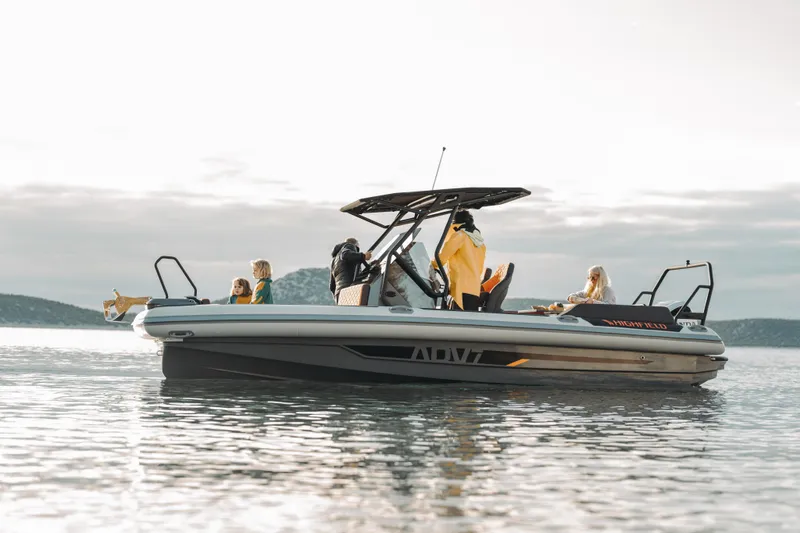 Slide: The Image of 2026 Highfield ADV7 boat on calm water with passengers enjoying the ride. - 2